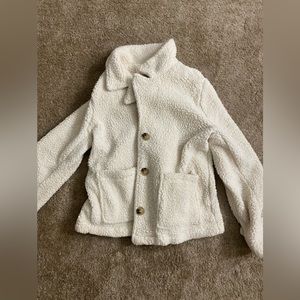 Cream colored teddy jacket with brown buttons. Great for fall.